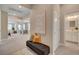 Inviting hallway with bench seating and views into the living and dining areas plus a peek at the bathroom at 9903 Spinel Pl, Las Vegas, NV 89143
