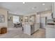Open-concept kitchen with stainless steel appliances, a kitchen island, and a dining area with modern decor at 9903 Spinel Pl, Las Vegas, NV 89143
