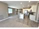 Modern kitchen with stainless steel appliances, white cabinets, granite countertops, and an island with a sink at 9903 Spinel Pl, Las Vegas, NV 89143
