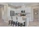 Stylish kitchen with white cabinets, granite countertops, stainless appliances, and an island with seating at 9903 Spinel Pl, Las Vegas, NV 89143