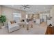 Open-concept living area featuring a comfy sofa, a modern ceiling fan, and plenty of natural light at 9903 Spinel Pl, Las Vegas, NV 89143