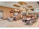 Spacious lounge area featuring modern decor, a large TV, ample seating, and an open kitchen at 9903 Spinel Pl, Las Vegas, NV 89143