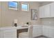 A stylish office area with built-in white cabinetry, desk, and modern decor at 9903 Spinel Pl, Las Vegas, NV 89143