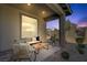 Relaxing covered patio featuring wicker furniture and decorative outdoor rug at 9903 Spinel Pl, Las Vegas, NV 89143