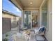 Cozy covered patio features comfortable seating and a seamless transition to indoor dining through sliding glass doors at 9903 Spinel Pl, Las Vegas, NV 89143
