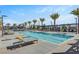 Lap pool surrounded by lounge chairs and palm trees, offering a relaxing outdoor experience at 9903 Spinel Pl, Las Vegas, NV 89143