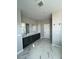 Elegant bathroom with a dual sink vanity and marble-look tile flooring providing a spa-like feel at 10280 Midnight Meteor Ave, Las Vegas, NV 89166