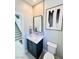 Modern powder room featuring gray paint, stylish fixtures and hardware and light wood floors at 10280 Midnight Meteor Ave, Las Vegas, NV 89166