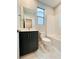 Bright bathroom featuring a dark vanity, toilet, tub, and shower at 10280 Midnight Meteor Ave, Las Vegas, NV 89166