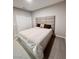 Simple bedroom with neutral color, carpet floors and a large bed at 10280 Midnight Meteor Ave, Las Vegas, NV 89166