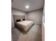 Cozy bedroom featuring a large upholstered headboard and neutral décor providing a calming aesthetic at 10280 Midnight Meteor Ave, Las Vegas, NV 89166