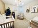 Adorable Bedroom with a crib, artwork, and comfortable chair, creating a sweet space at 10280 Midnight Meteor Ave, Las Vegas, NV 89166