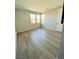 Simple bedroom with a light-colored hardwood floor and three windows at 10280 Midnight Meteor Ave, Las Vegas, NV 89166