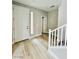 Bright entryway featuring hardwood floors, stylish wall trim and a view of the staircase at 10280 Midnight Meteor Ave, Las Vegas, NV 89166