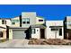 Two-story home featuring modern architecture, a two car garage and desert landscaping at 10280 Midnight Meteor Ave, Las Vegas, NV 89166