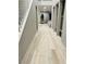 Long hallway featuring gray walls, light wood floors and access to the living area at 10280 Midnight Meteor Ave, Las Vegas, NV 89166