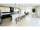 Spacious kitchen with a large island, modern lighting, and black and white cabinets at 10280 Midnight Meteor Ave, Las Vegas, NV 89166