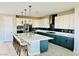 Modern kitchen with a spacious island with bar seating and white and blue cabinets at 10280 Midnight Meteor Ave, Las Vegas, NV 89166