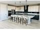 Bright kitchen featuring a central island with seating, stainless steel appliances and stylish pendant lighting at 10280 Midnight Meteor Ave, Las Vegas, NV 89166