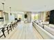 Open-concept living room with white sofa, wood floors, island seating, and sliding glass doors at 10280 Midnight Meteor Ave, Las Vegas, NV 89166