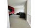 This living room features a stylish sofa and a distinctive red accent wall, perfect for entertaining at 10280 Midnight Meteor Ave, Las Vegas, NV 89166