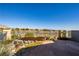 The backyard features an elevated deck with a custom stone waterfall and mountain views at 10336 Birch Bluff Ln, Las Vegas, NV 89145