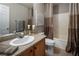 Well-lit bathroom featuring a vanity sink, a tub and shower, and contemporary decor at 10336 Birch Bluff Ln, Las Vegas, NV 89145