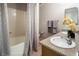 Bathroom featuring a tub and shower combination and double sinks with decorative accents at 10336 Birch Bluff Ln, Las Vegas, NV 89145