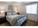 Comfortable bedroom featuring a queen bed, neutral carpeting, and a window with natural light at 10336 Birch Bluff Ln, Las Vegas, NV 89145