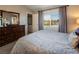 Bedroom with a large dresser, a bed, plush carpet, and a window with mountain views at 10336 Birch Bluff Ln, Las Vegas, NV 89145