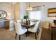 Charming dining area with seating for six, a stylish chandelier, and lots of natural light at 10336 Birch Bluff Ln, Las Vegas, NV 89145