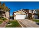 Charming two-story home with a two-car garage, set against a clear blue sky at 10336 Birch Bluff Ln, Las Vegas, NV 89145