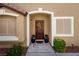 Inviting front entrance with a decorative wreath, potted plants, and manicured landscaping at 10336 Birch Bluff Ln, Las Vegas, NV 89145