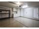 This garage features a clean epoxy floor, built-in cabinets and shelving for optimal storage at 10336 Birch Bluff Ln, Las Vegas, NV 89145