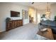 Spacious living room featuring a mounted TV, carpeted flooring, and neutral wall color at 10336 Birch Bluff Ln, Las Vegas, NV 89145