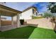 Inviting backyard with artificial turf and a covered patio, perfect for outdoor gatherings and leisure at 10512 Mann St, Las Vegas, NV 89141