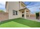 Well-maintained backyard with artificial turf and a covered patio, offering a perfect blend of relaxation and entertainment at 10512 Mann St, Las Vegas, NV 89141