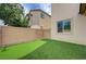 Lush backyard with artificial turf, ideal for low-maintenance enjoyment and outdoor activities at 10512 Mann St, Las Vegas, NV 89141