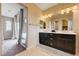 Bathroom with double vanity, walk in closet, and linen closet at 10512 Mann St, Las Vegas, NV 89141