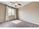 Bedroom with neutral paint, large window, and ceiling fan with light at 10512 Mann St, Las Vegas, NV 89141