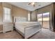 A well-lit bedroom features a modern bed frame, side tables, and a sliding glass door with neutral color paint at 10512 Mann St, Las Vegas, NV 89141