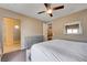 A bright and spacious bedroom featuring a plush bed, a dresser, and an open bathroom with an easy access shower at 10512 Mann St, Las Vegas, NV 89141