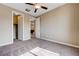 Bedroom featuring two doors, neutral paint, carpet, and ceiling fan with light at 10512 Mann St, Las Vegas, NV 89141