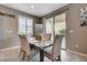 Bright dining area features modern table, chairs, and sliding glass doors to a charming outdoor space at 10512 Mann St, Las Vegas, NV 89141