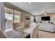 An inviting dining area with modern decor, a rustic table, and a view of the outdoor patio through sliding glass doors at 10512 Mann St, Las Vegas, NV 89141