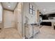 Welcoming entryway with tile flooring, a decorative mirror console, and access to the modern kitchen at 10512 Mann St, Las Vegas, NV 89141