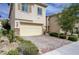 Charming home featuring a two-car garage, paved driveway, and well-maintained landscaping at 10512 Mann St, Las Vegas, NV 89141