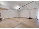 Spacious two-car garage featuring neutral walls and epoxy flooring, providing ample room for vehicles and storage at 10512 Mann St, Las Vegas, NV 89141