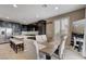 Modern kitchen featuring stainless steel appliances, a center island with bar seating, and dark cabinets at 10512 Mann St, Las Vegas, NV 89141
