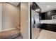 A stainless steel refrigerator complements dark wood cabinets and a tile backsplash in this well-equipped kitchen space at 10512 Mann St, Las Vegas, NV 89141